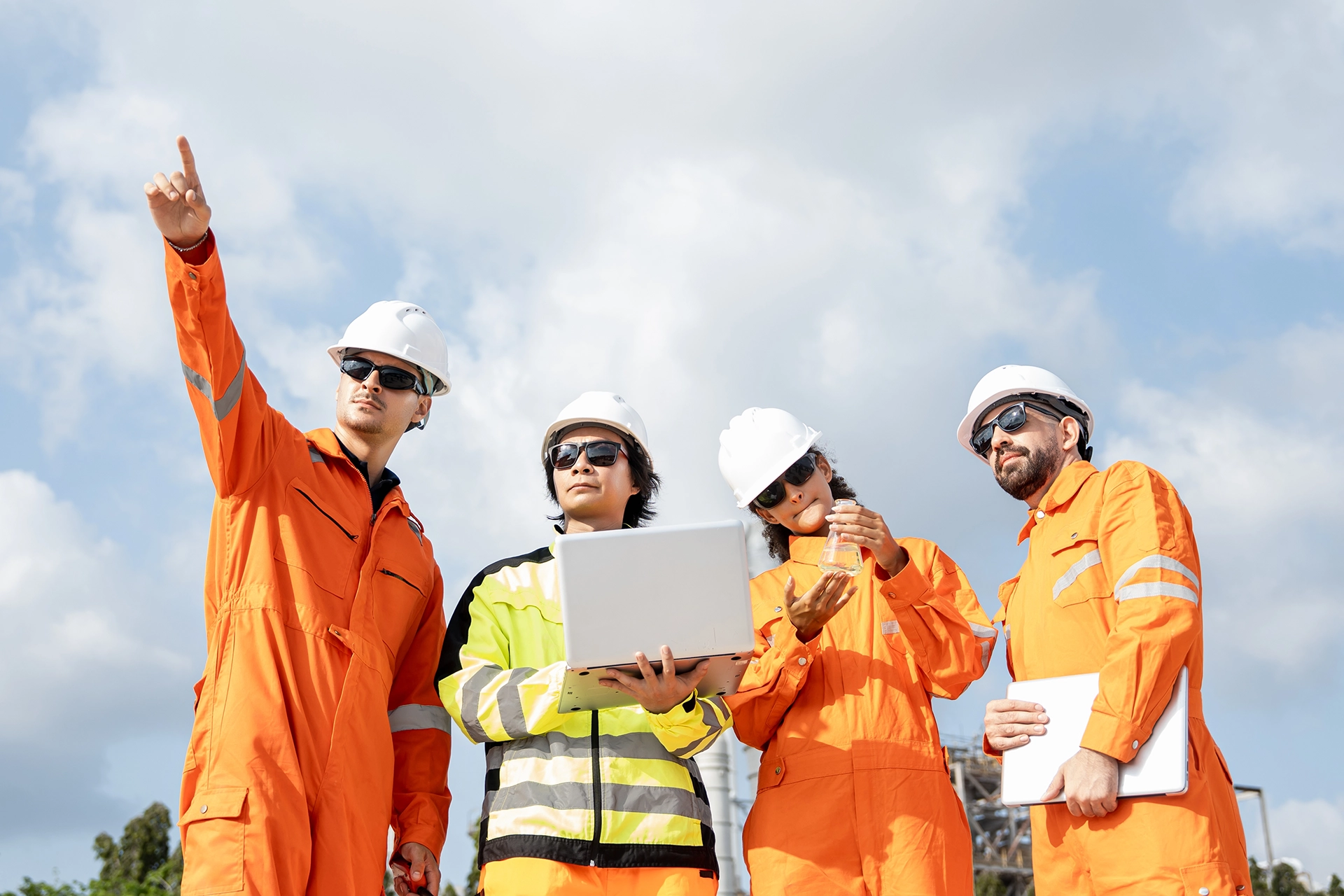 Industrial engineering team reviewing project plans at a facility