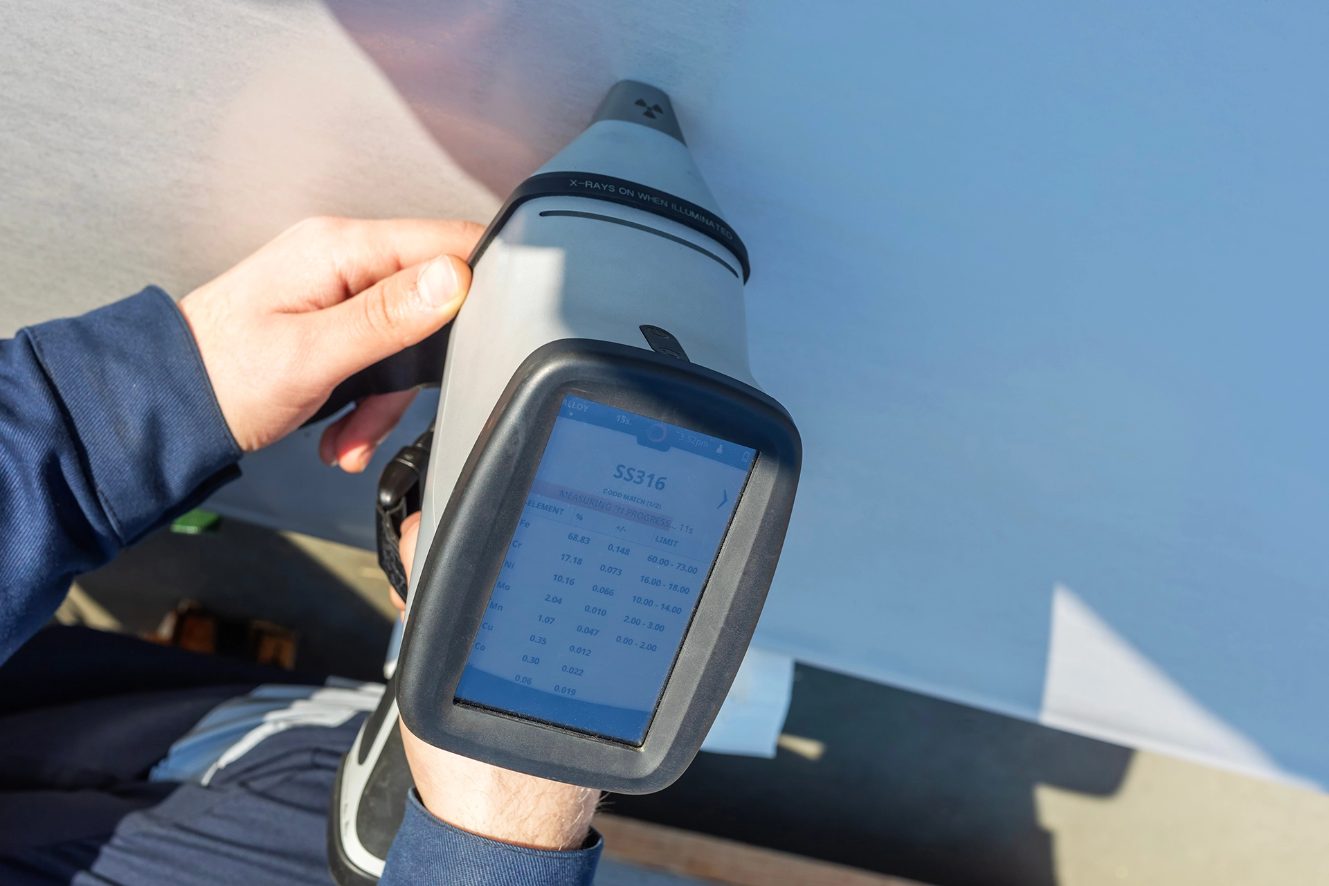 Inspector performing PMI and XRF material verification on industrial metal